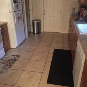 Can you find the large dog hiding in this kitchen? Can you find the large dog hiding in this kitchen?